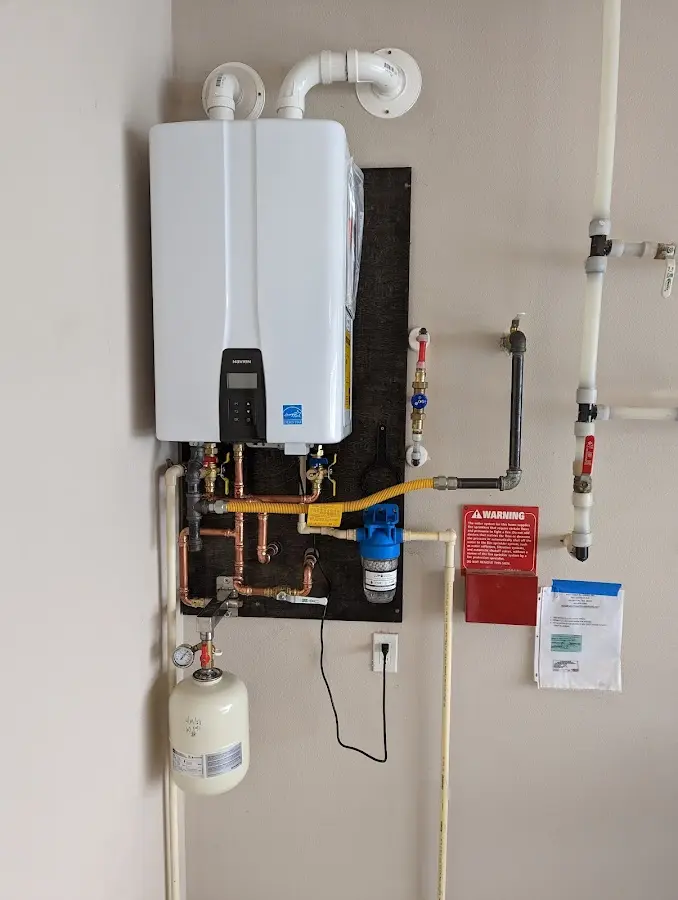 Professional plumber installing copper piping in a Glen Rock home